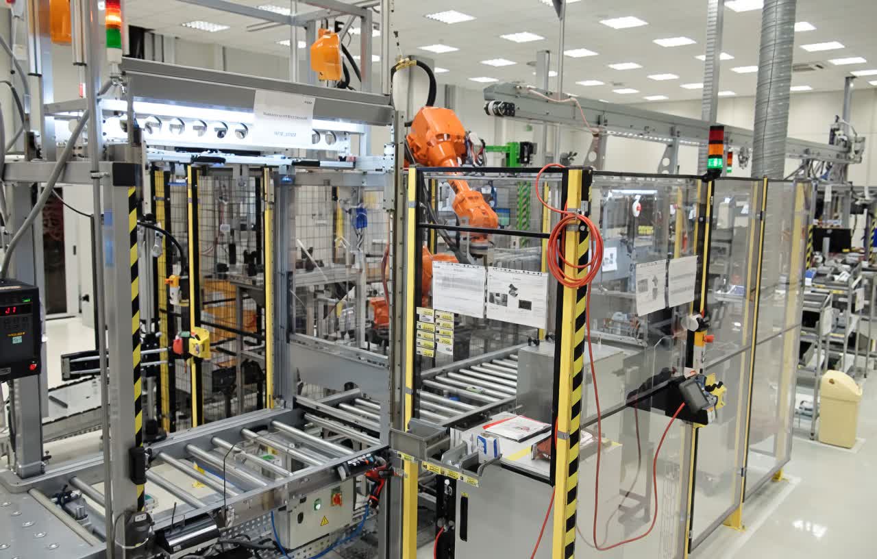 Battery box sealing station with automated adhesive application and curing